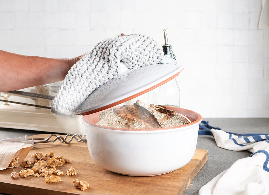 Römertopf Brottopf aus Naturton mit Deckel – Brot richtig aufbewahren für langanhaltende Frische Römertopf Brottopf aus Keramik mit Deckel, naturfarben, stehend auf einer Küchenarbeitsplatte – zur Aufbewahrung von Brot, um es länger frisch zu halten.